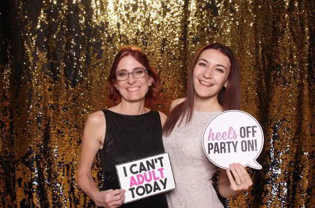 two ladies posing for a party photo booth rental experience in va