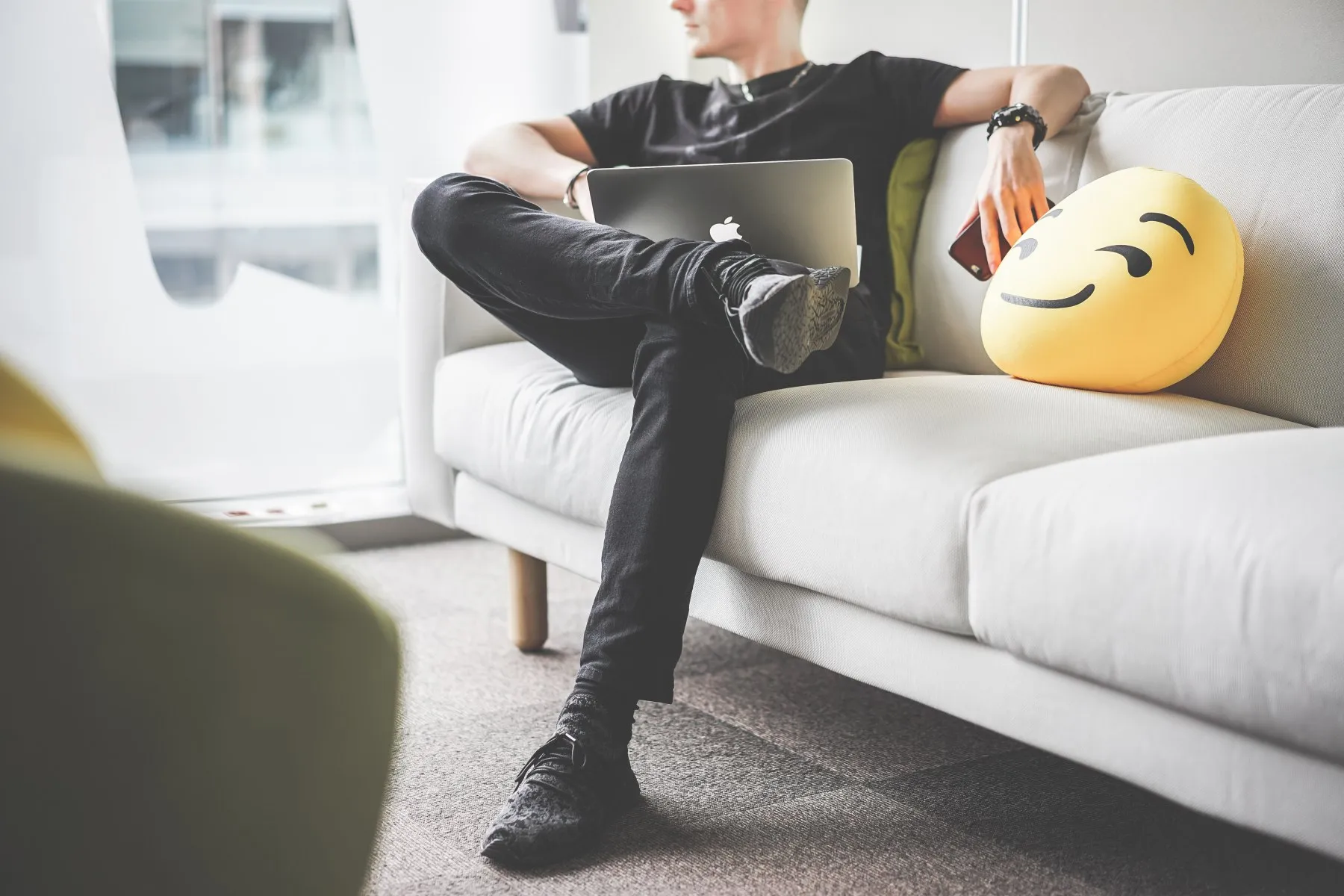 man siting on couch happy he contacted our ai content services